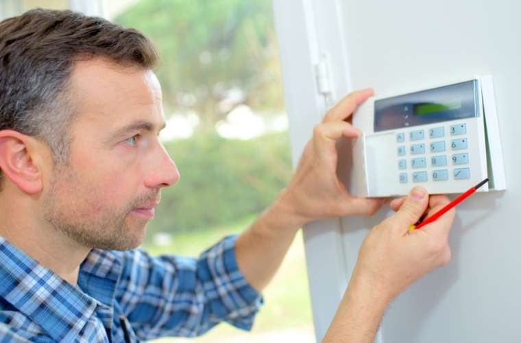 dependent-electrical-employee-installing-home-security-system